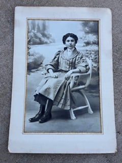 Large Antique Hand-Retouched Portrait Photograph – Signed “Fae” 1909 – Charcoal Enhanced: Large antique portrait photograph of a seated young woman, dated 1909 and signed “Fae.” This piece has been hand-retouched with charcoal or pastel, visible in the hair and signature area, wher