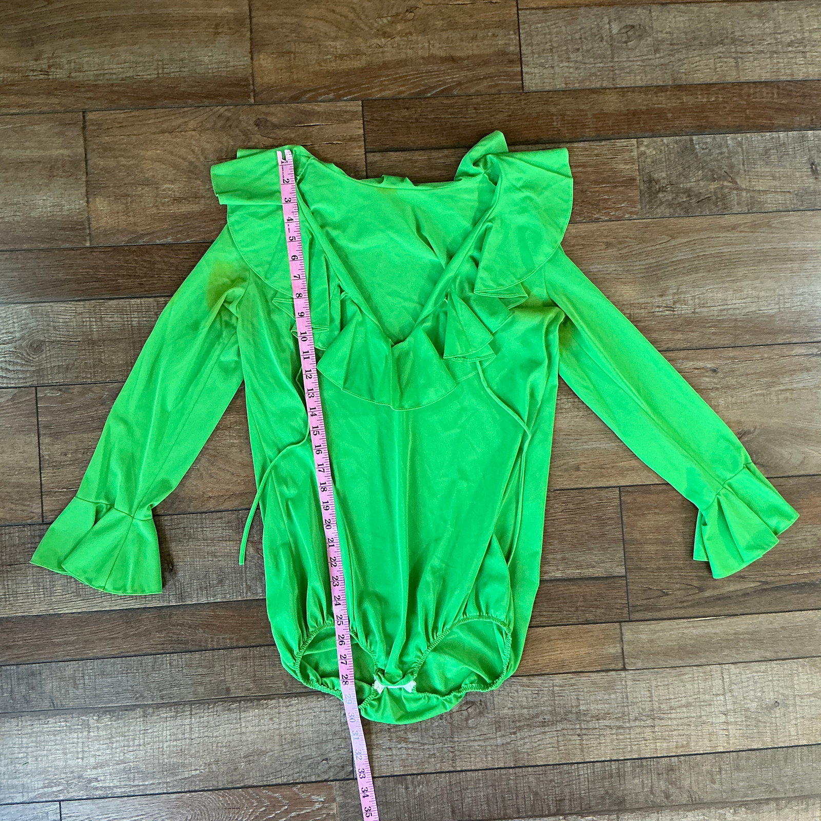 Vintage 70s 80s Neon Green Ruffle Bodysuit Miss Elaine Lingerie Costume Festival S/M: Bold vintage late 1970s to early 1980s Miss Elaine neon green bodysuit.Features dramatic ruffle neckline and cuffs, long sleeves, and high-cut leg with snap closure. Eye-catching statement piece perfe