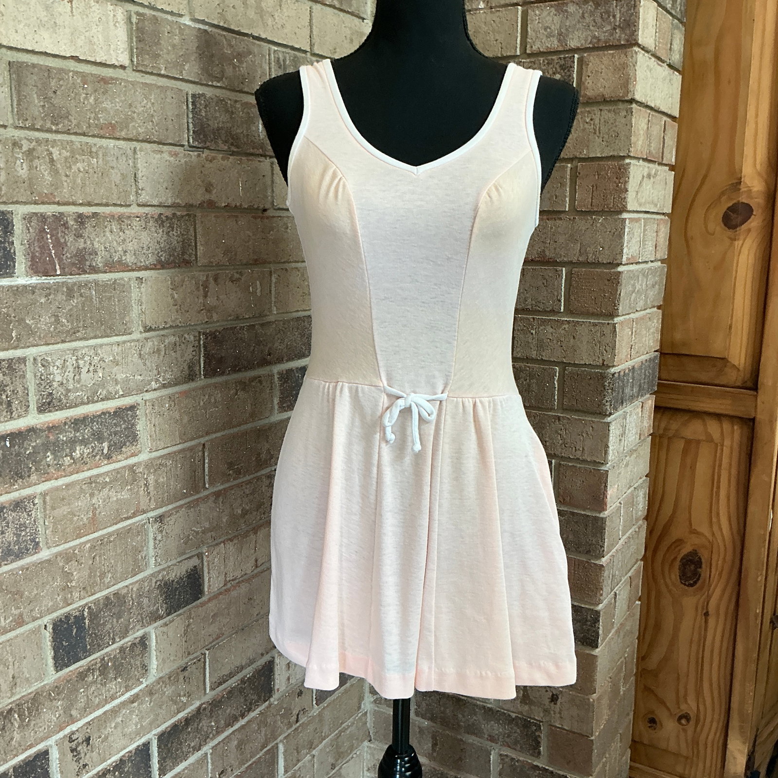 Vintage Pale Pink Sleeveless Fit & Flare Dress, Ballet Style: Vintage sleeveless dress in a soft pale pink tone, featuring a flattering fit-and-flare silhouette with a gently gathered skirt. The bodice has subtle paneling for shape, wide shoulder straps, and a f