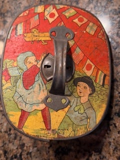 Vintage Heart Shaped Tin Noisemaker Toy Dancing Animals Lithograph: Vintage heart-shaped tin noisemaker toy featuring colorful lithographed dancing animal figures on a bright red background. The design includes bears, rabbits, and other animals in playful poses with m