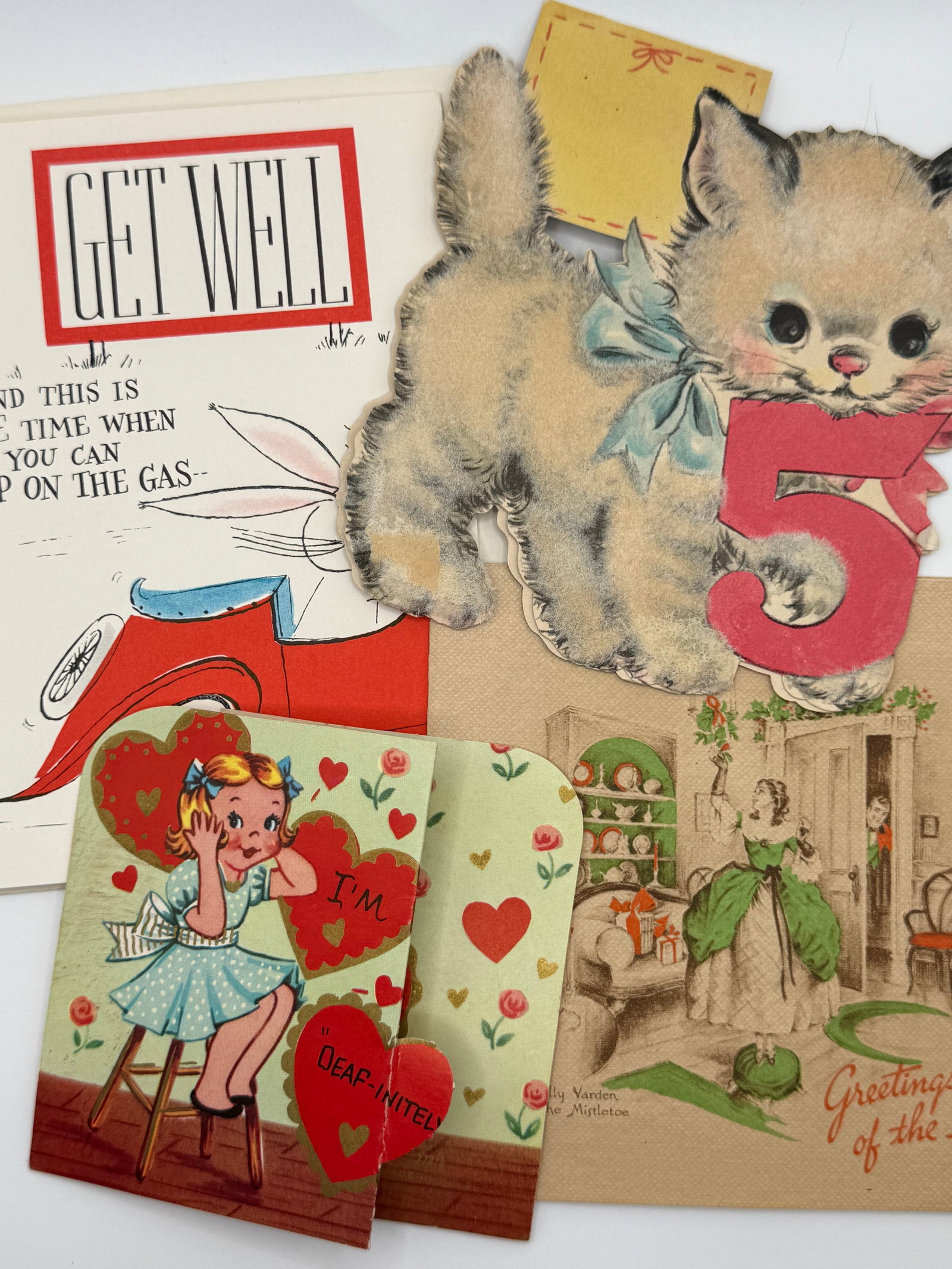 4 Vintage Greeting Cards & Die-Cuts – Kitten “5” Birthday, Valentine Fold-Out, Get Well &: Collection of four vintage greeting cards and die-cut pieces featuring a mix of holiday, birthday, and novelty themes from the mid-20th century.Included:Die-cut kitten with large “5”, likely a
