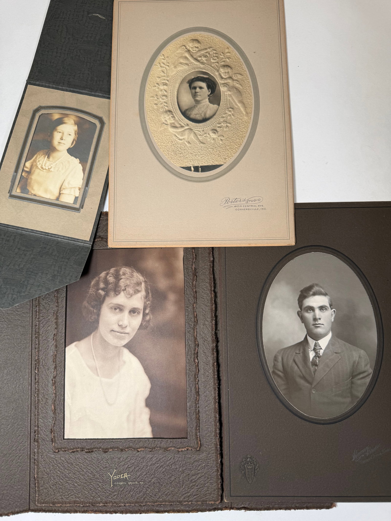 Antique Cabinet Card Portrait Lot – Embossed Mat, Studio Photography (Yoder & Potter Studios): Grouping of four antique cabinet card photographs, featuring formal studio portraits mounted on decorative cardstock.Includes:Oval portrait of a young man in suit and tie, clean and well-definedLarge