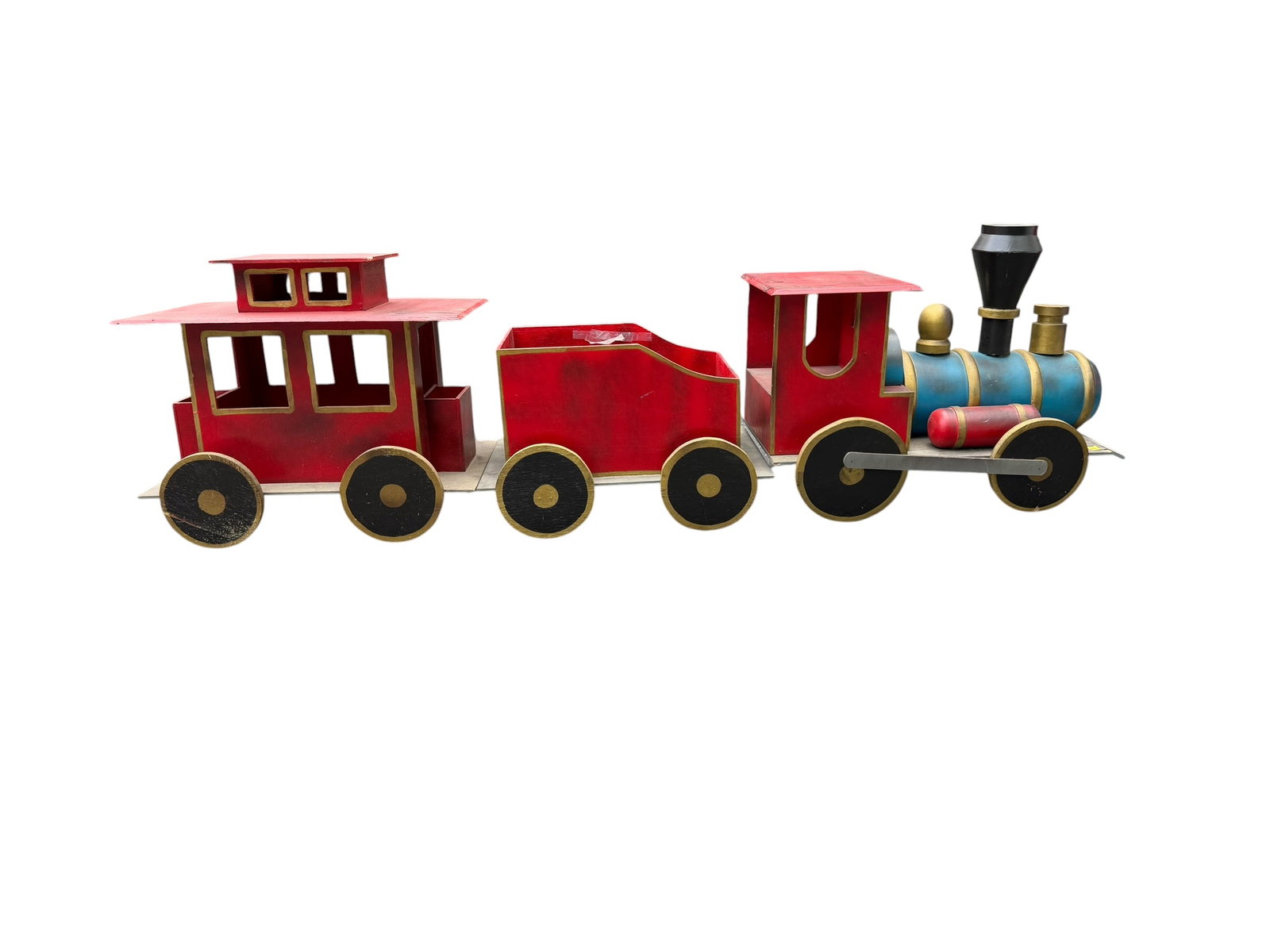 Vintage Neiman Marcus Oversized Decorative Holiday Train Display: Large vintage decorative wooden train display set attributed to Neiman Marcus, featuring a whimsical oversized locomotive with matching tender and caboose in painted red, blue, black, and gold finishe