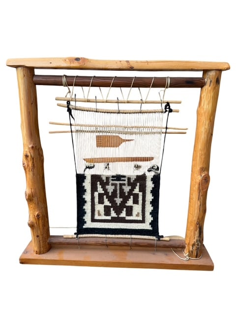 Navajo Miniature Weaving Loom Display – Two Grey Hills Trading Post, Tohatchi NM: Charming miniature Navajo weaving loom display featuring a handwoven geometric textile mounted on a rustic wood loom frame. This decorative Southwestern piece includes miniature weaving tools and reta