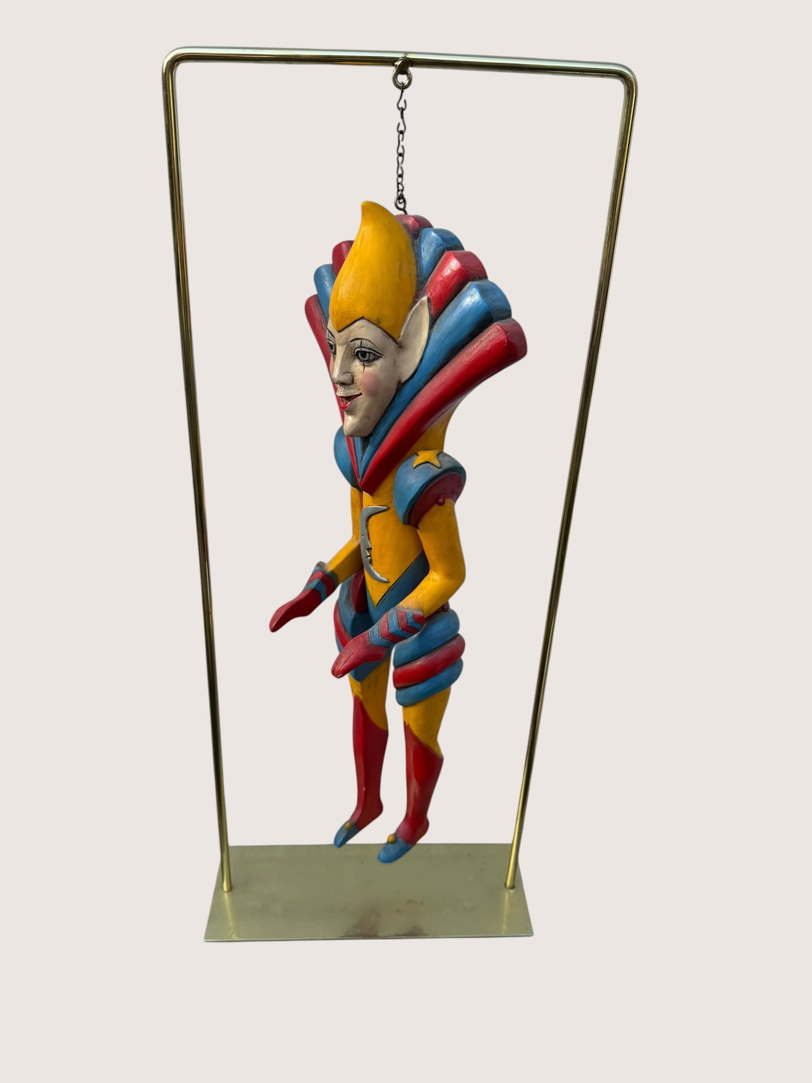 Vintage Hand-Carved Art Deco Harlequin Marionette Sculpture – Colorful Hanging Jester Figure on: Striking vintage hand-carved wooden marionette or hanging theatrical figure displayed on a modern brass-tone stand. This whimsical Art Deco / fantasy-inspired character features dramatic geometric sty