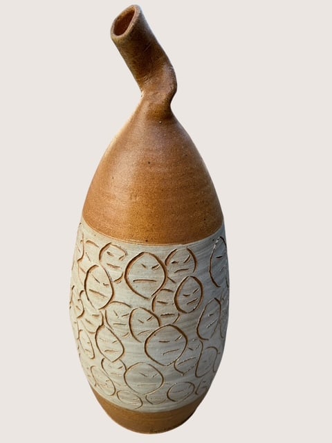 Large Signed Studio Pottery Bottle Vase with Abstract Face Motif & Twisted Neck: Exceptional large studio pottery bottle vase featuring an expressive hand-carved abstract face motif repeated around the body and accented with a striking cobalt blue medallion signature mark. The scu