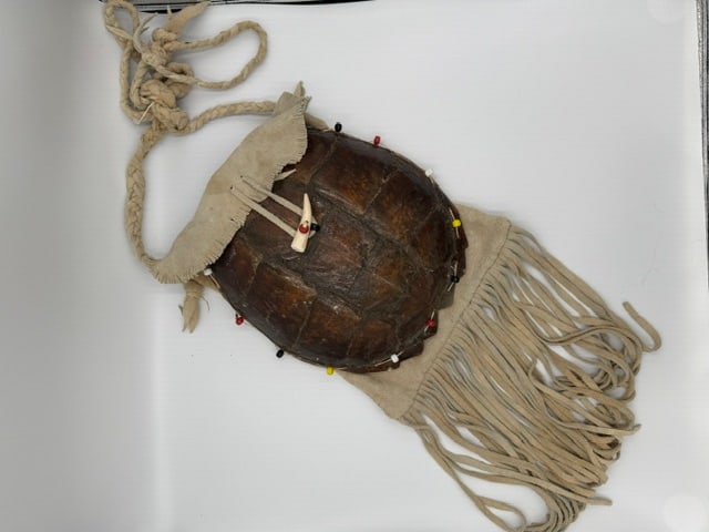 Native American Style Turtle Shell Dance Rattle / Ceremonial Pouch with Leather Fringe: Handcrafted Native American style ceremonial turtle shell rattle or medicine pouch featuring a genuine turtle shell mounted to soft suede leather with long fringe detailing and bead accents. The shell