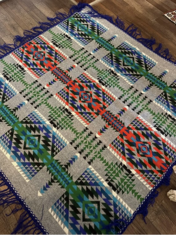 Vintage Pendleton Beaver State Wool Blanket Native American Geometric Fringe Throw: Vintage Pendleton Beaver State wool blanket featuring bold Native American inspired geometric patterns in blue, green, red, black, and gray tones. Finished with blue fringe trim along the edges.Label 