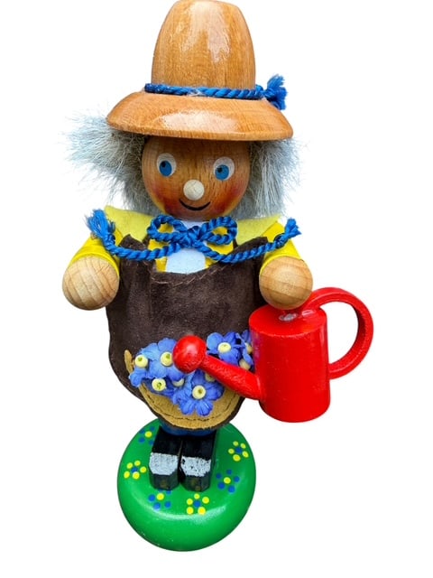 Steinbach Germany Handcrafted Gardener Wooden Figure with Watering Can & Flowers: Authentic handcrafted Steinbach Germany wooden gardener figure from the famed Erzgebirge (Ore Mountains) region. This cheerful character wears a wide-brimmed hat, yellow shirt, brown apron, and blue t