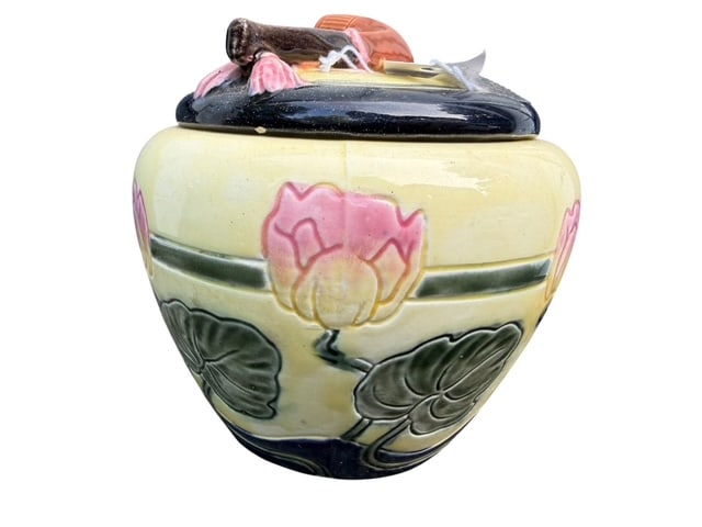 Maling Newcastle Lotus Majolica Tobacco Jar & Pipe Lid, England: Charming Maling Pottery majolica tobacco jar featuring a molded lotus blossom and lily pad decoration in shades of pink, green, cream, and deep cobalt blue. The fitted lid incorporates an integrated p
