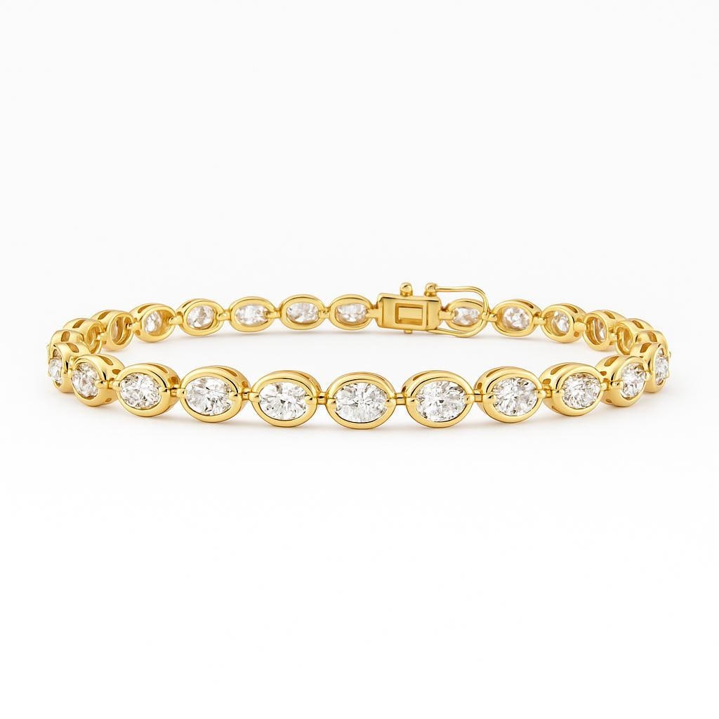 Lab Grown Oval Shape Diamond Bezel Prong Tennis Bracelet 3.90 Carats E-F VVS2-VS1 14K: Lab Grown tennis bracelet featuring 21 Oval diamonds weighing 3.90 Carats in a bezel-prong setting, in 14 Karat Yellow Gold. Average Diamonds 0.19 Points Each. Color E-F Clarity VVS2-VS1