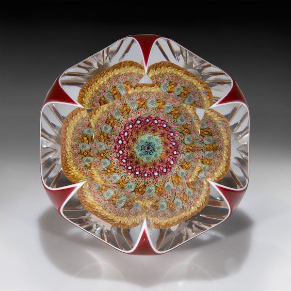 Baccarat: Baccarat 1970 red overlay millefiori mushroom paperweight. The mushroom, composed of concentric complex canes in rose, pink, yellow, gold and white, has a tapered stem on clear ground. Red-over-white 
