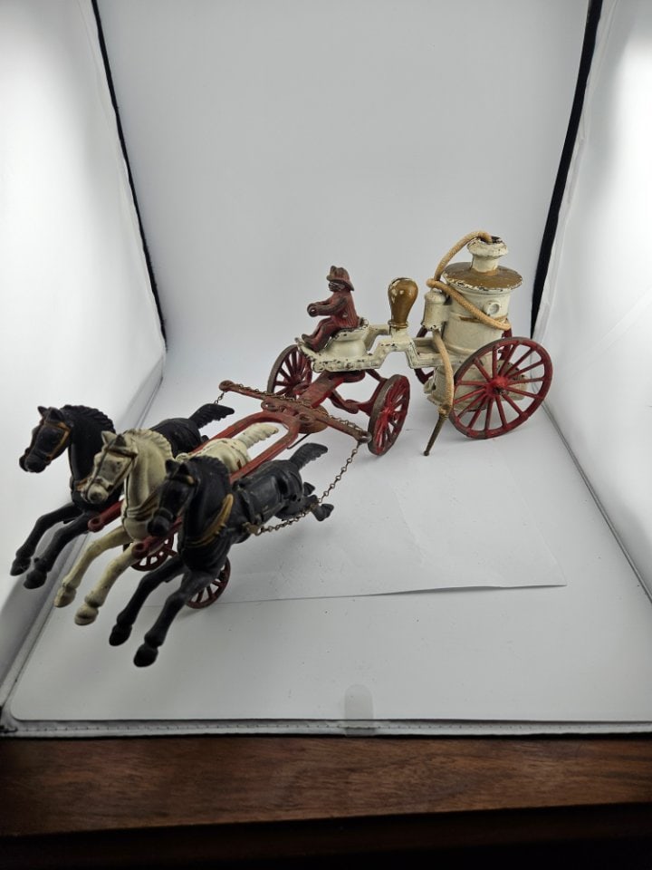 Dent Cast Iron Horse-Drawn Fire Pumper.: Dent Cast Iron Horse-Drawn Fire Pumper. Includes 3 Horses Out Front, in Galloping Mode, Pulling the Pumper, Which Has All Its Wheels and Hose. Missing a Piece Connecting the Driver to the Pumper.