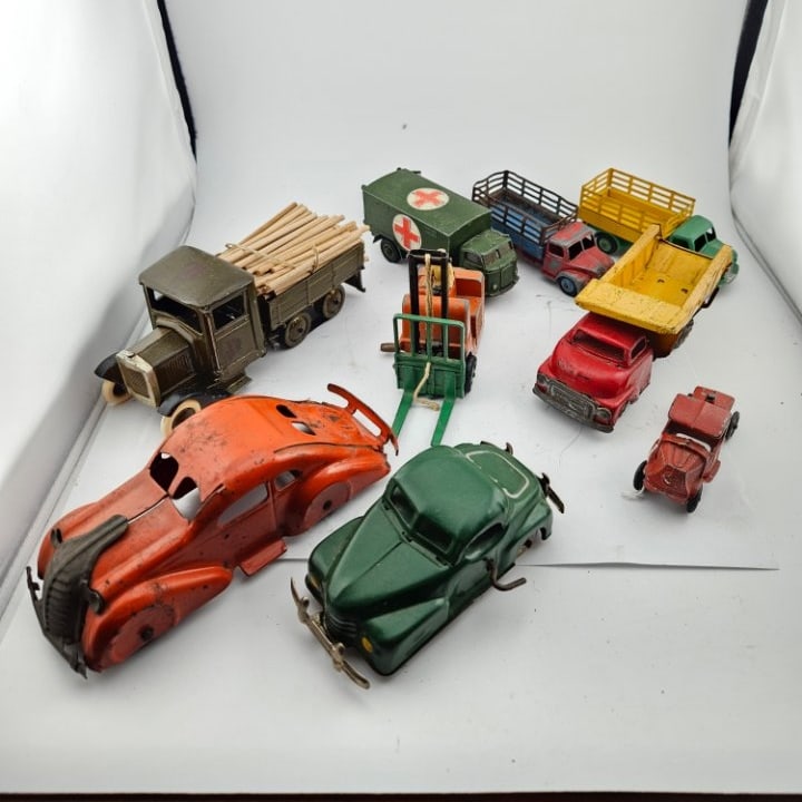 Group of Nine All Metal Vehicles.: Group of Nine All Metal Vehicles. Includes an Ambulance, Dump Truck, Forklift, a Log Truck, and Others. There are 4 by Dinky, One by Britains, One by Tootsie, and there is One Windup Vehicle, as Well.
