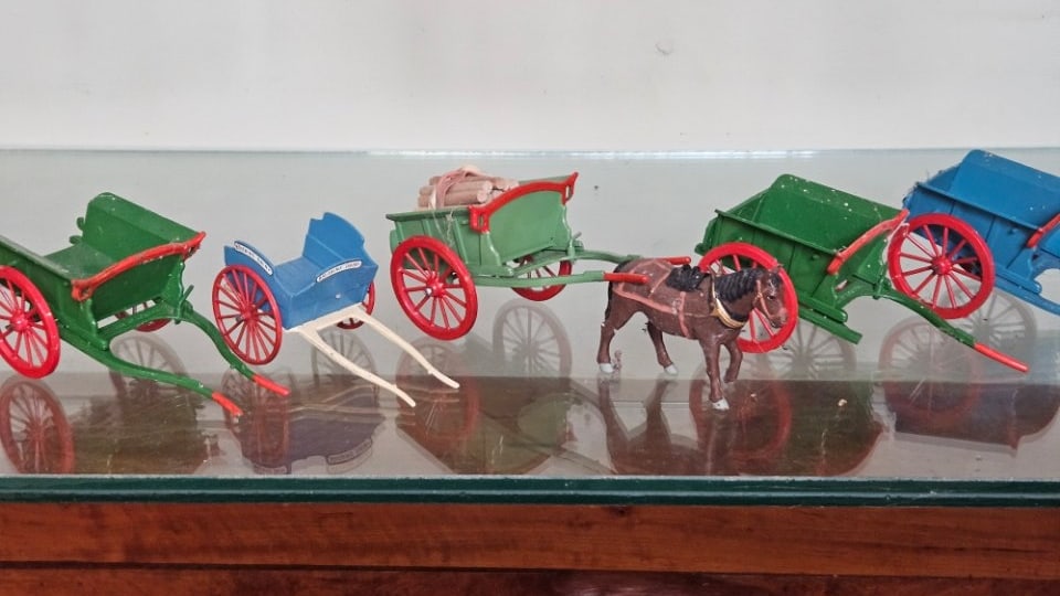 Lot of Six Antique Handpainted Horsedrawn Wagons by Britains.: Lot of Six Antique Handpainted Horsedrawn Wagons by Britains. Includes a Dairy Cart, a Log Cart, and Several Carriages. One Has a Broken Connecting Shaft.