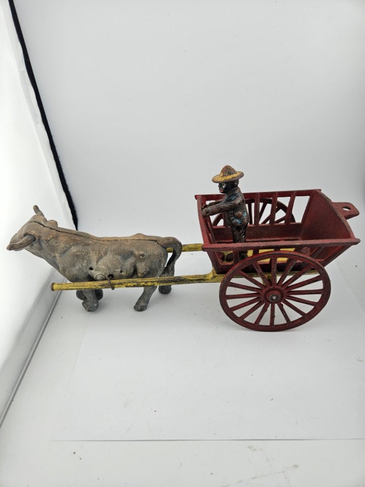 Vintage Cast Iron Ox Cart with Driver: Vintage Cast Iron Ox Cart with Driver. 12" long and in fairly good condition.