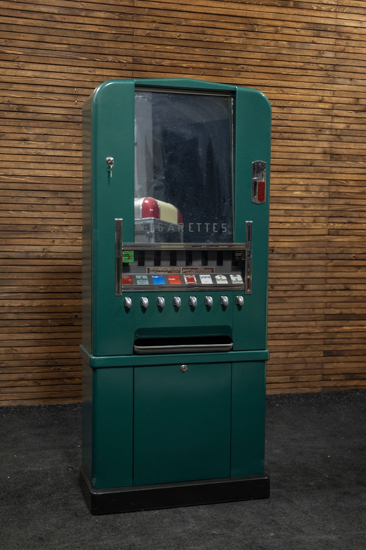 Lehigh PX Cigarette Machine - Restored: Circa late 1940s, this coin-operated dispenser offers eight different selections which are shown in a lighted window, cosmetic restoration with metallic green finish, new wiring, 110V. 
