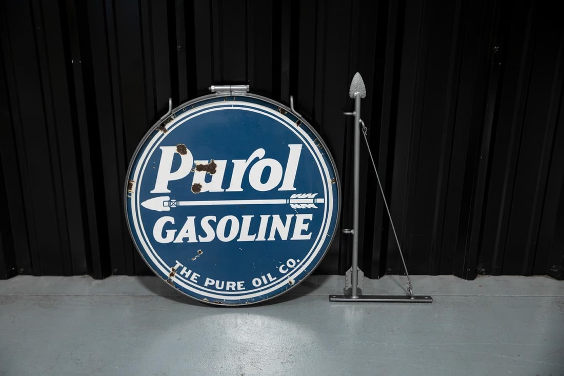 Purol Gasoline Double-Sided Hanging Porcelain Sign: White on dark blue, DSP good color and shine, shows wear and loss in the field on both sides, complete with original ring and gray painted arrow bracket. Rated 7.75