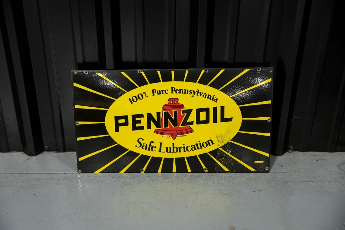 Pennzoil Safe Lubrication Single-Sided Porcelain Sign: SSP with good color and gloss, features Pennzoil logos with bright yellow burst. Showing some thinning and wear to the porcelain on the right side. Marked "Made in USA" and retains the original