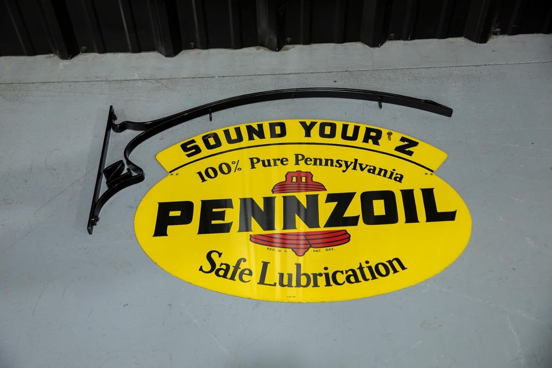 Pennzoil Double-Sided Porcelain Sign with Hanging Bracket: DST with good color and shine, telling motorists to sound their "Z". Minor surface rubs on both sides. Marked AM7-62. Rated 8.75
