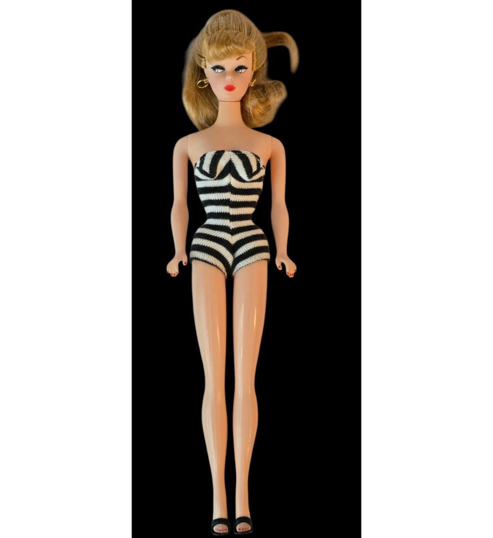 A Vintage Barbie Doll: Vintage Barbie Doll. Measures approx. 12" X 2 5/4" X 2". See pics. All items must be retrieved or shipped within 15 days of auction end. Items remaining in our possession after this time will be subje