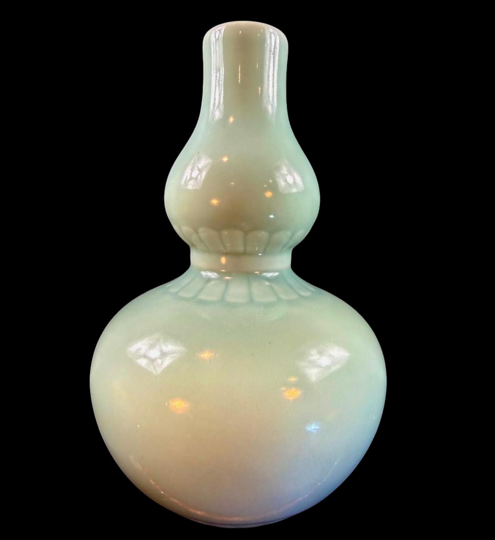 Magnificent antique powder blue monochrome double gourd form porcelain vase: Magnificent antique powder blue monochrome double gourd form porcelain vase standing 11.5” tall and 7” wide. Bears an under glazed blue Qianlong mark. PLEASE NOTE THIS ESTATE AND ITEMS ARE