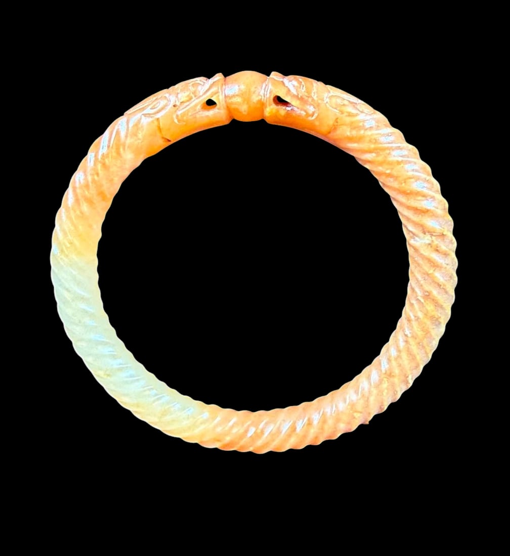 Antique Chinese Jade yellow and white nephrite jade carved bangle, Earlier Or Qing Period: Antique Chinese Jade yellow and white nephrite jade carved bangle designed as confronting dragons holding the flaming pearl. Qing dynasty or earlier. Measures 3.1” outside diameter and 2.4&rdquo