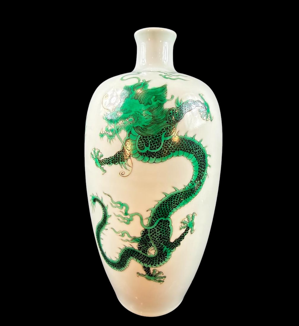 Fine Chinese porcelain bottle form vase decorated with a dragon chasing a flaming pearl Kangxi Mark: Chinese porcelain bottle form vase decorated with a dragon chasing a flaming pearl. The dragon is masterfully executed. Vase bears a honorary Kangxi mark. Most likely a Guangxu 19th century made vase.