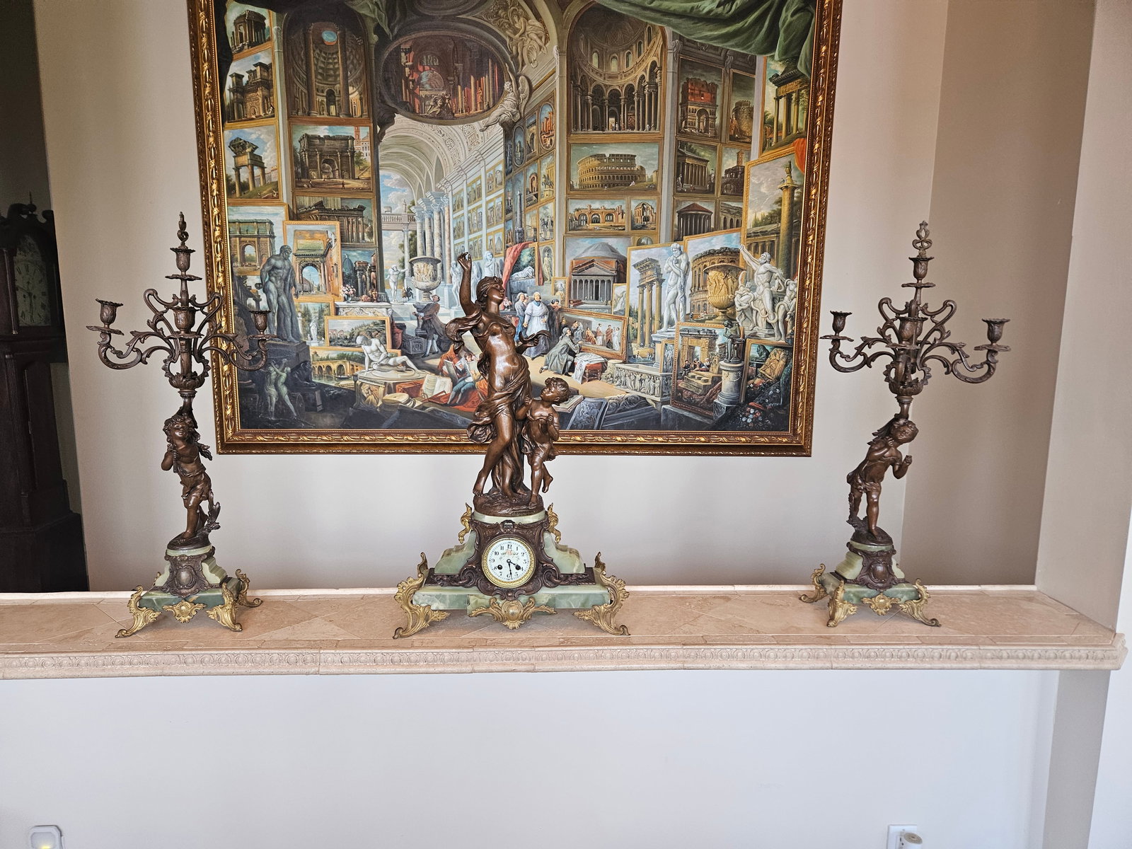 L'Inspiration clock garniture set circa 1868 : The Hippolyte François Moreau L'Inspiration clock garniture set circa 1868 is a classic example of 19th-century French decorative art, typically featuring a central mantel clock and a pair of mat