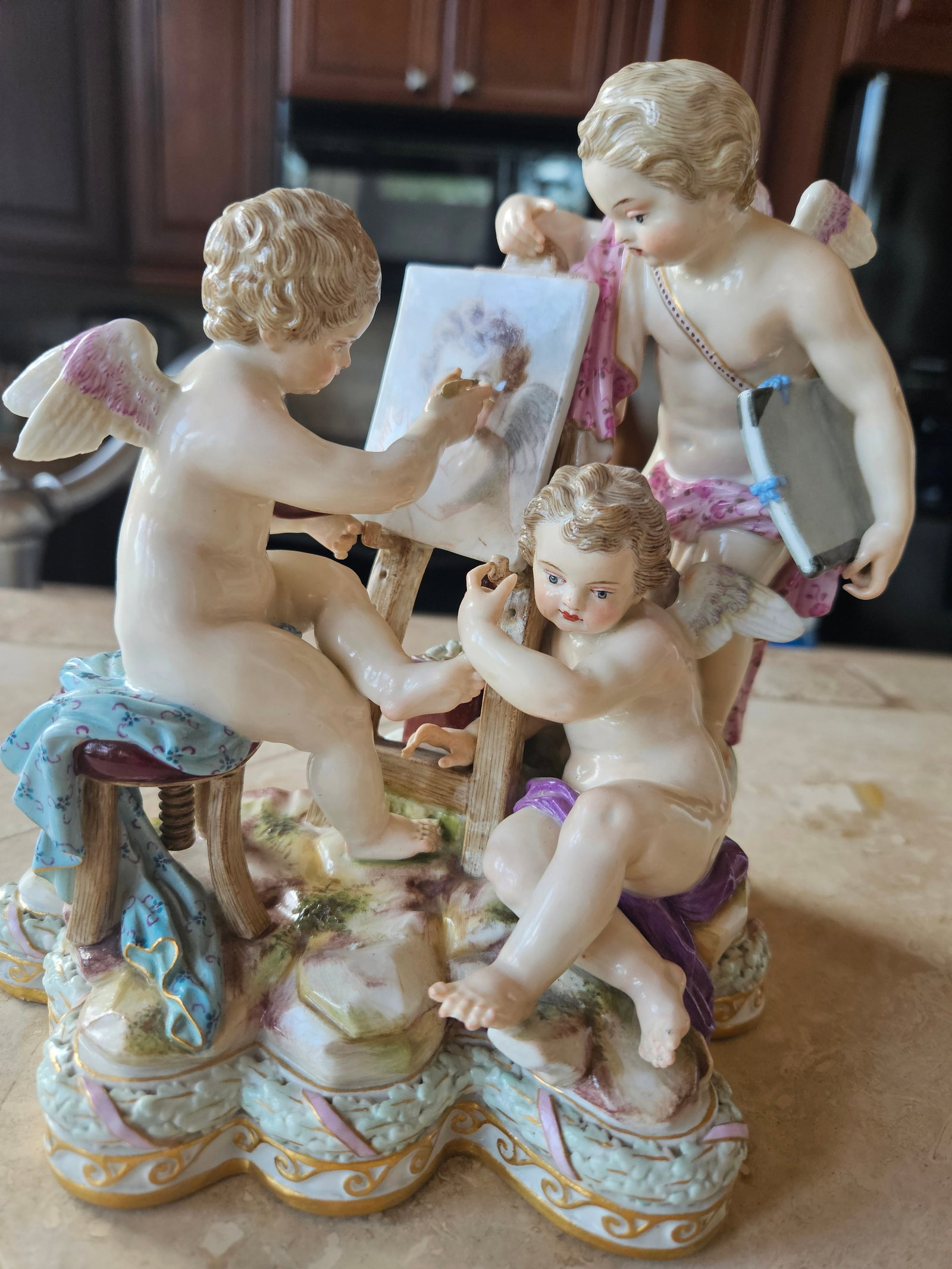 Meissen Allegory of Painting : The Meissen Allegory of Painting (or Die Malerei) typically exists in two primary forms: the 18th-century cherub group designed by Michel Victor Acier and the later 19th-century female figure designed