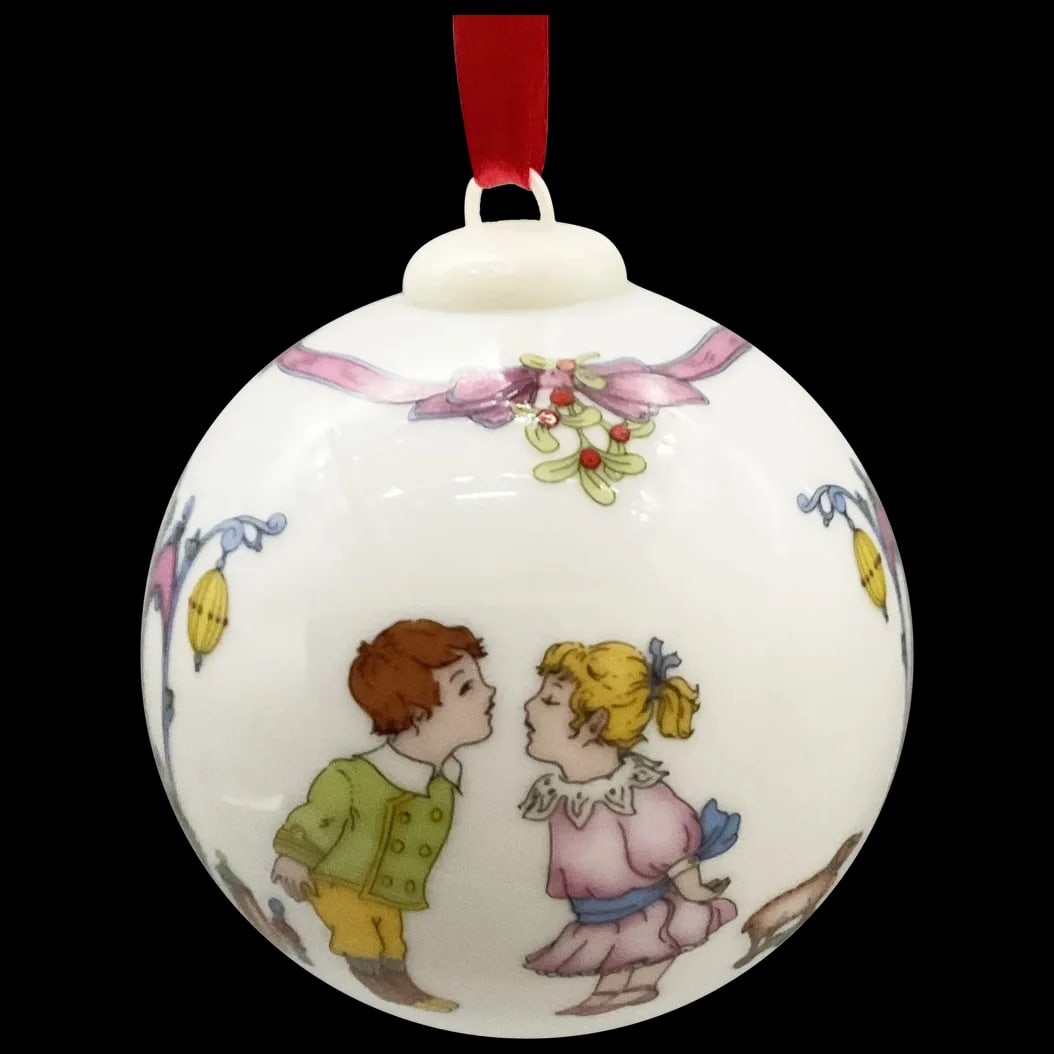 2002 Christmas Ornament: Weihnachts Kugel 2002 Porcelain Charming Under the Mistletoe Ornament from the Old Winther Collection by Rudolf Pastor Limited Edition portraying a Little Boy and Little Girl preparing to kiss under t