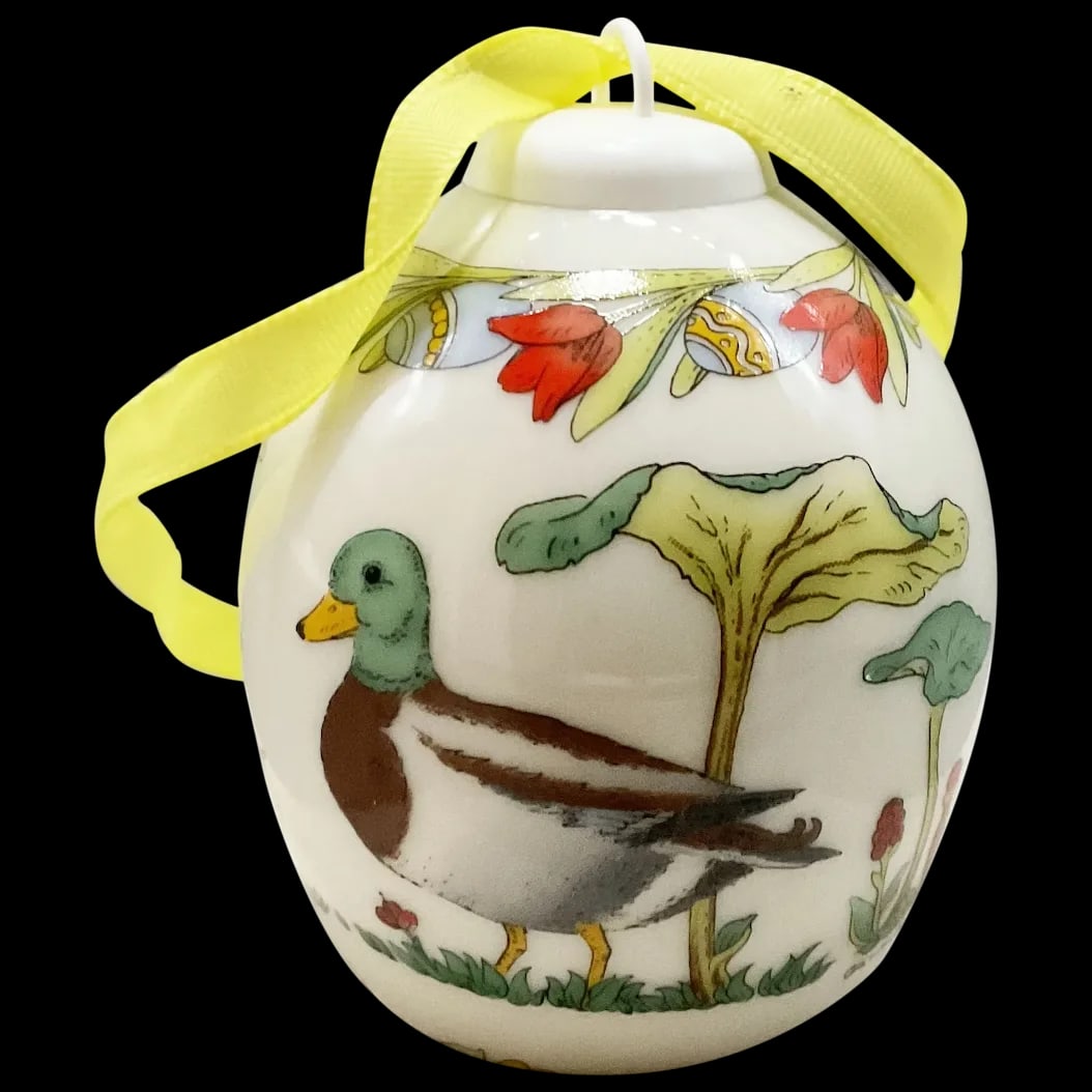 Easter Egg Ornament: Hutschenreuther 2002 Easter Egg Ornament signed Limited Edition Portraying Mama and Baby Ducklings scurrying to greet proud Papa. This little charmer with a yellow ribbon in its original box.