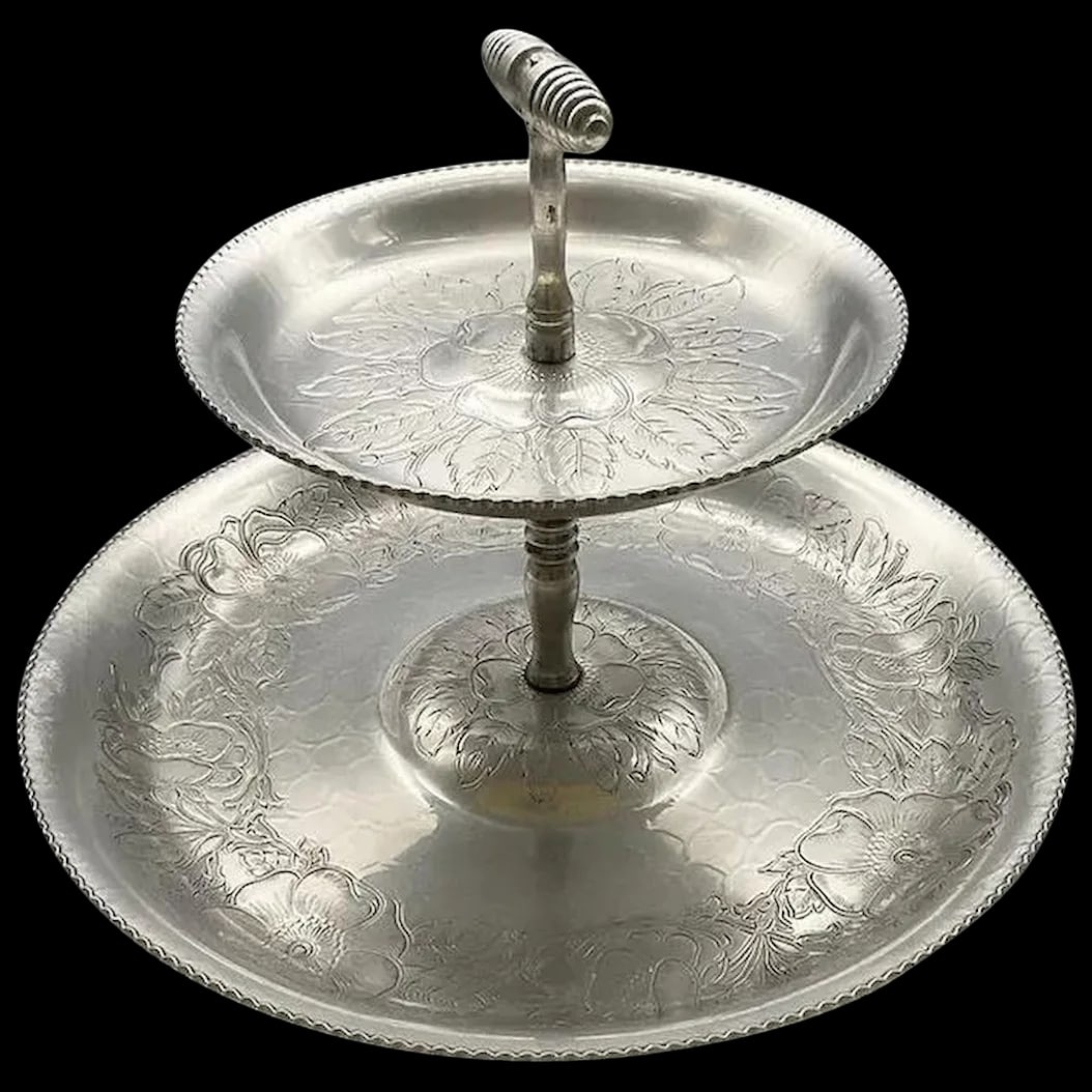 Two-Tier Aluminum Tray: Wilson Specialities Co. , Brooklyn, NY. 1950’s Mid century Hand-wrought aluminum tray. It has two tiers in an embossed dogwood pattern. This tray will display your Holiday appetizers and