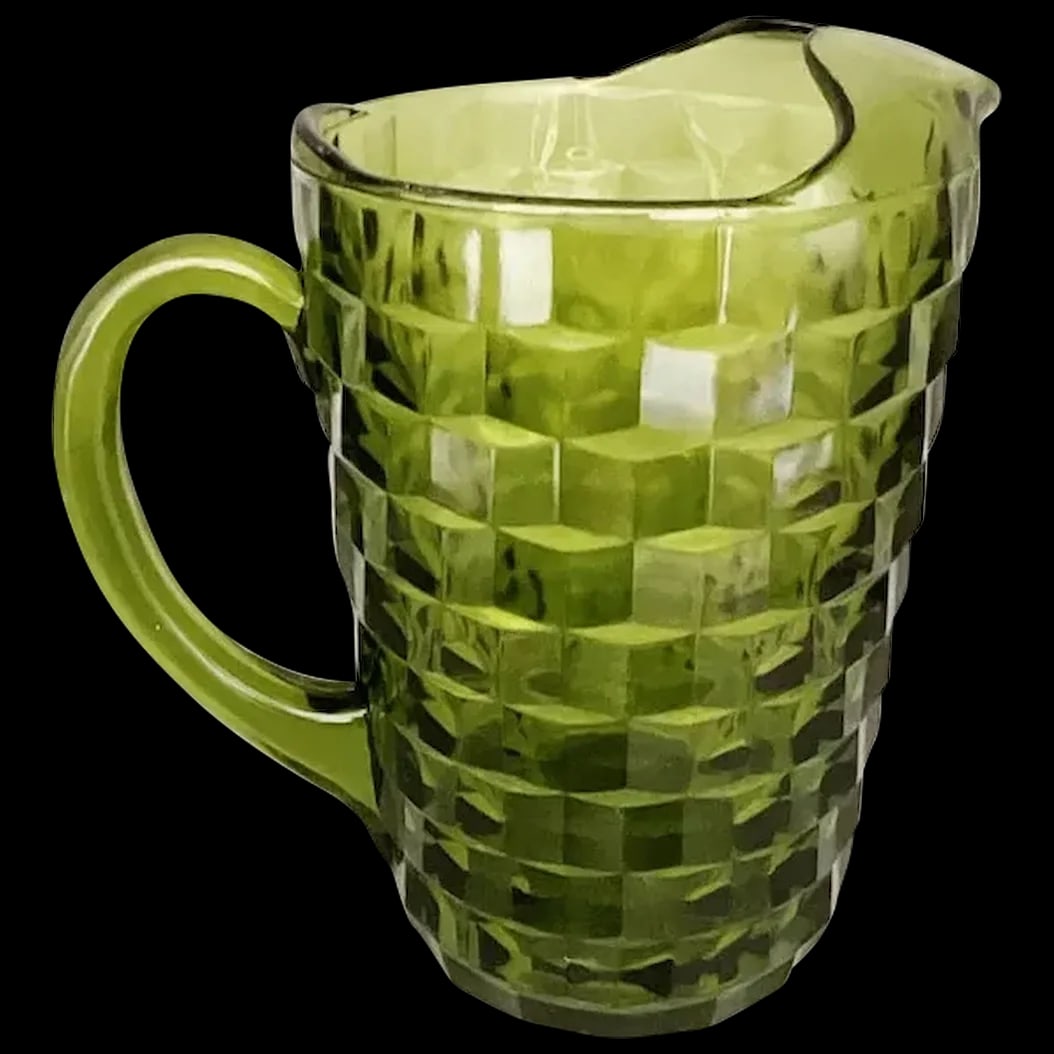Glass Pitcher: Olive Green American Pitcher Heavy Glass in Cube 3 D Pattern. The glass is thick and heavy. Made by Fostoria ca., 1960’s and highly collectible.