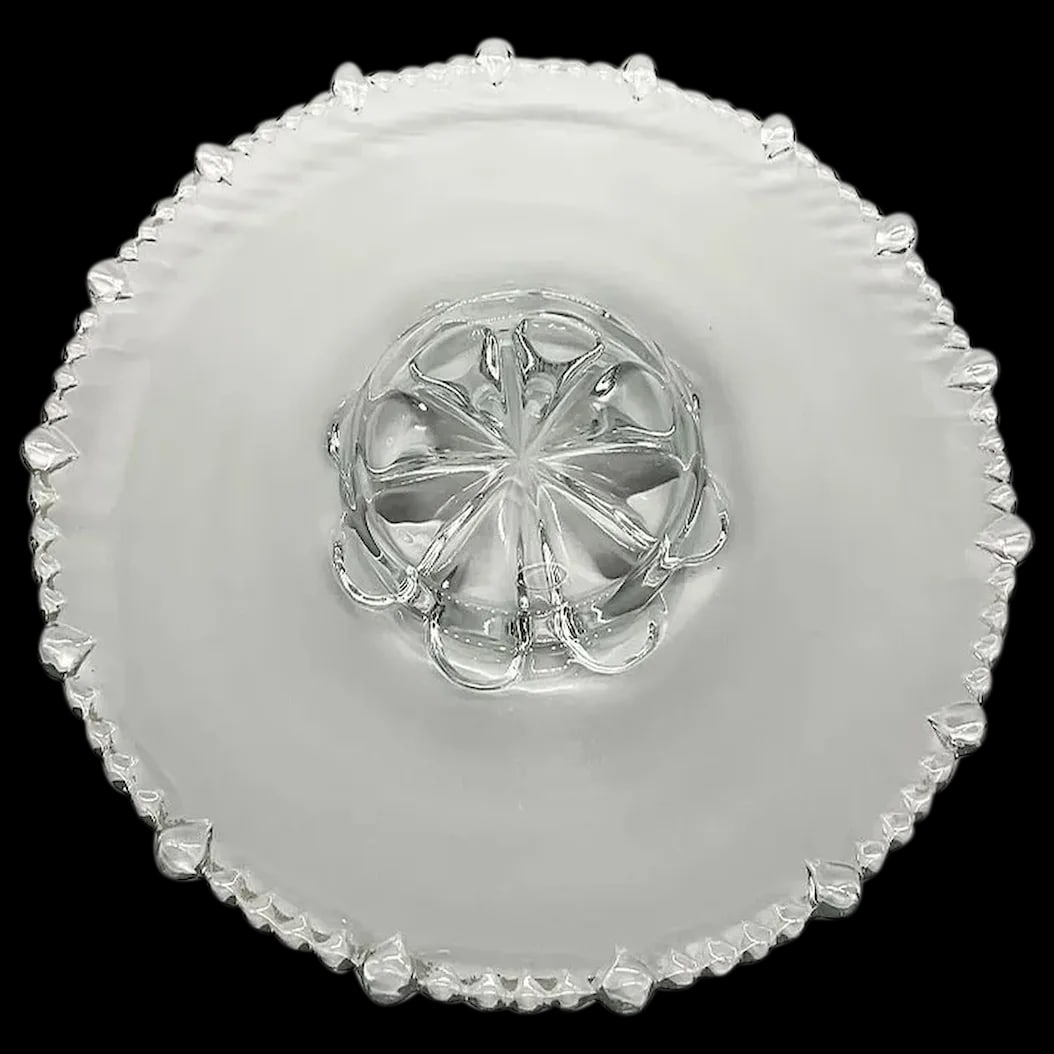 Vintage Glass Platter: Clear Glass Tray with Teardrop beaded Trim. The center of the platter is an embossed area for olives or dipping. It measures 12 inches across. Has some fine scratches but no chips or cracks. It presen