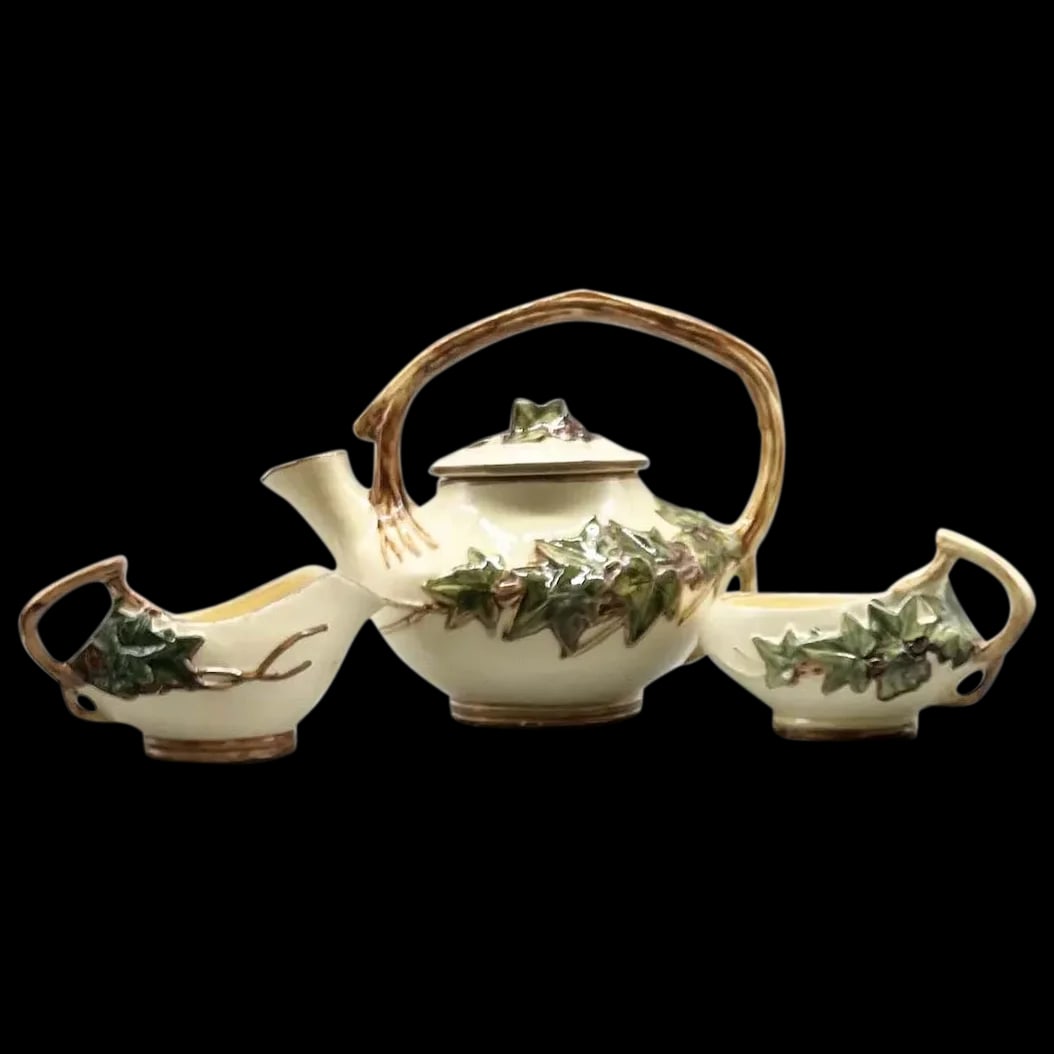 McCoy Ivy Tea Set: Vintage McCoy Ivy Tea set 3 pieces 1940’s. Using only three colors it really is a beautiful work of art. The colors are cream base with embossed green ivy leaves and embossed brown vine handle.