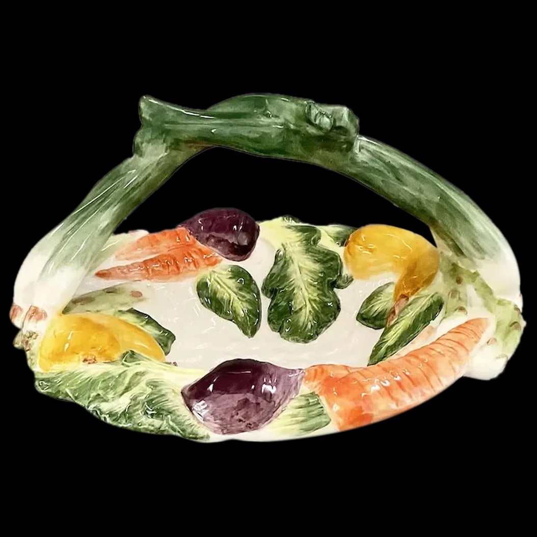 Ceramic Basket: Fitz and Floyd Percy the Pig Basket portrays a white basket made up of green scallion handles, orange carrots, purple beets, yellow squash and a yellow pepper.