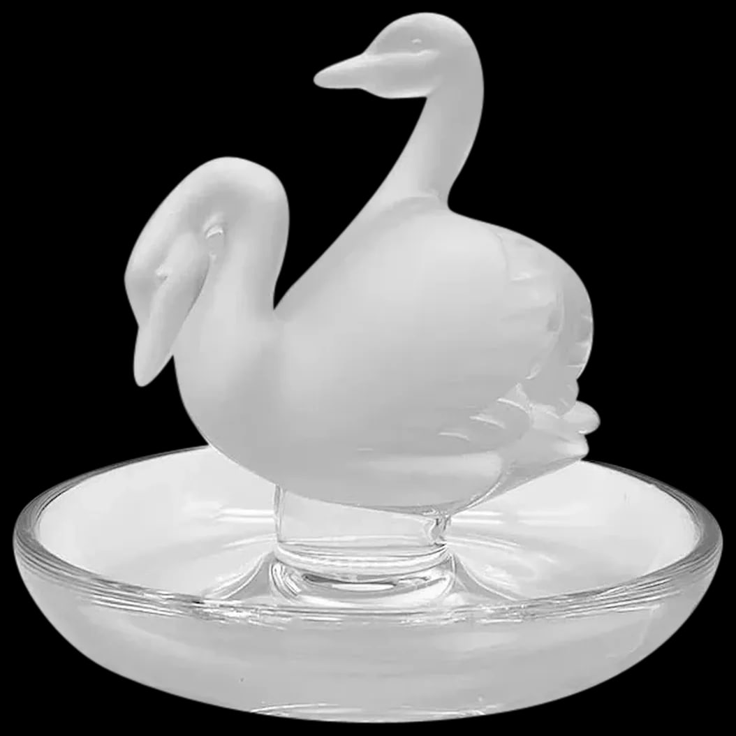 Ring Tray: Lalique Deux Cygnes Two Swans . The Swan, the symbol of grace and felinity is expressed so elegantly in this tray. The Swans are satin crystal. The tray is clear glass and present beautifully