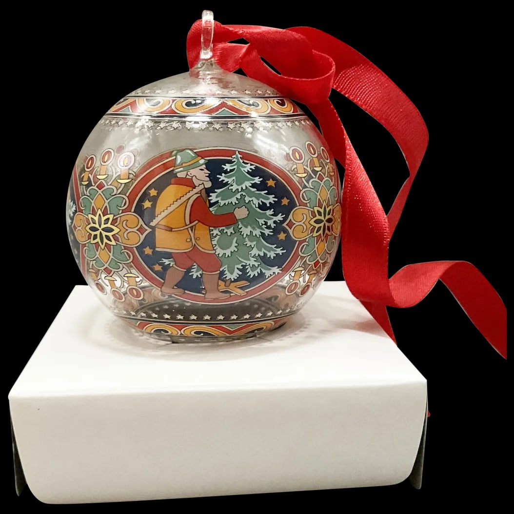 Christmas Ornament: Hutschenreuter Crystal Ornament called Austria by Artist Rudolf Pastor signed on bottom featuring an Austrian Gentleman with his axe, saw and sled in tow heading up the mountain in search of the