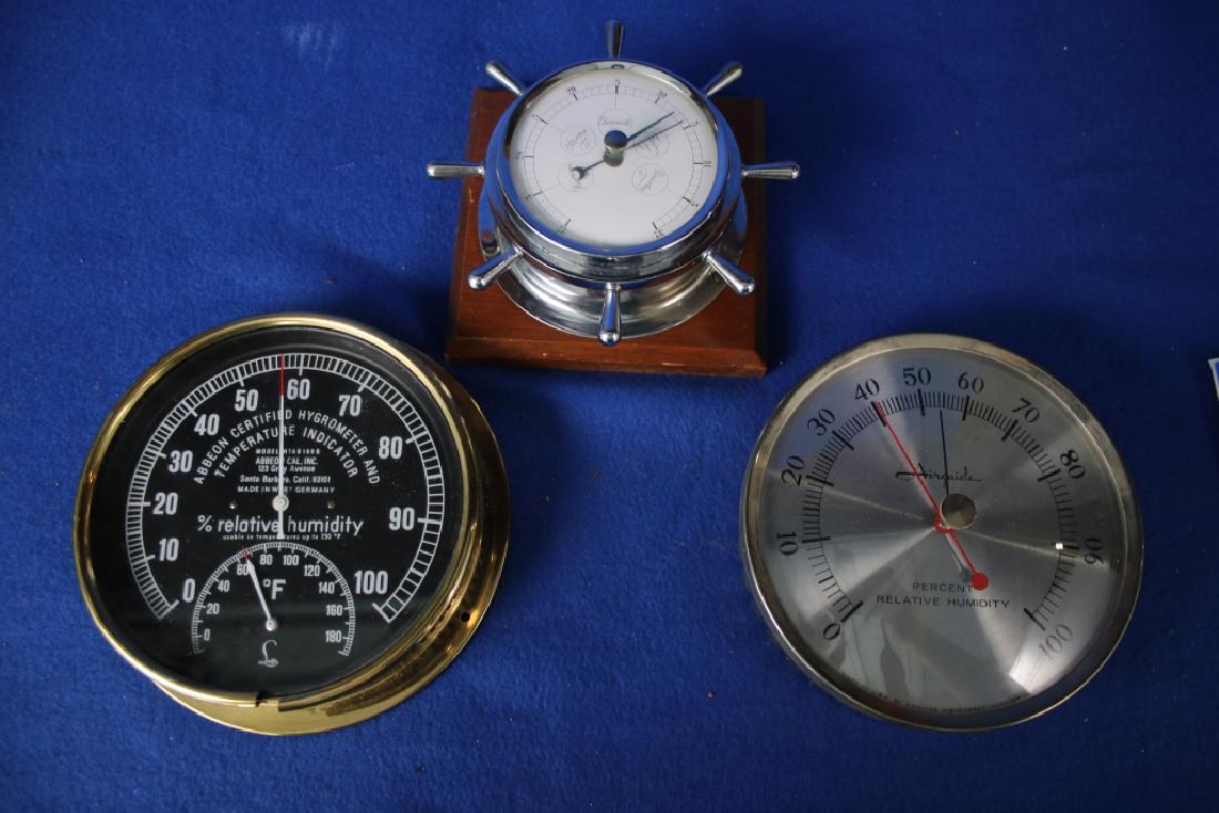3 Instruments: One Abbeon Hygrometer and Temperature Indicator by Abbeon Cal, Inc., Santa Barbara, CA; One Airguide Relative Humidity Gauge; One barometer in the shape of a ship's wheel
