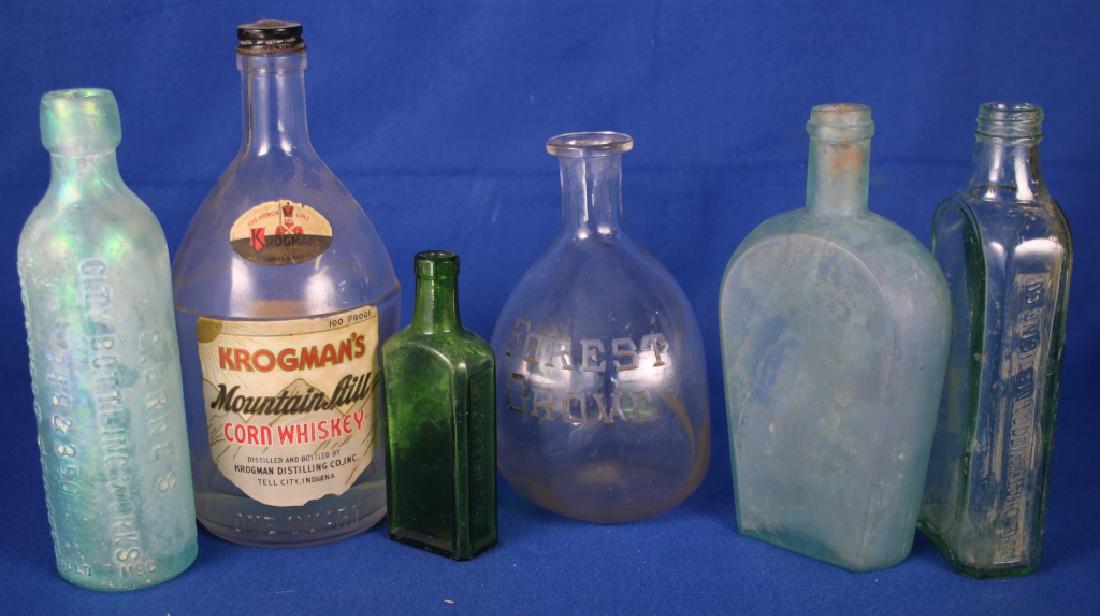 6 Miscellaneous Bottles: One C. Erne's Bottling Co., New Orleans, LA; Two medicine bottles, one is Chatanooga, TN; Forest Grove pinched whiskey; Krogman's whiskey; Unmarked flask