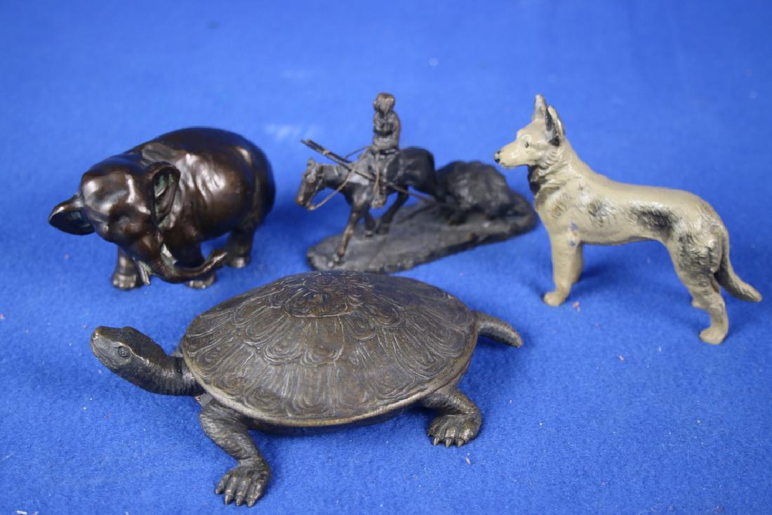 4 Small Metal Figurines: One hinged turtle w/female figure; One elephant; One dog; One Indian on horse pulling a pack