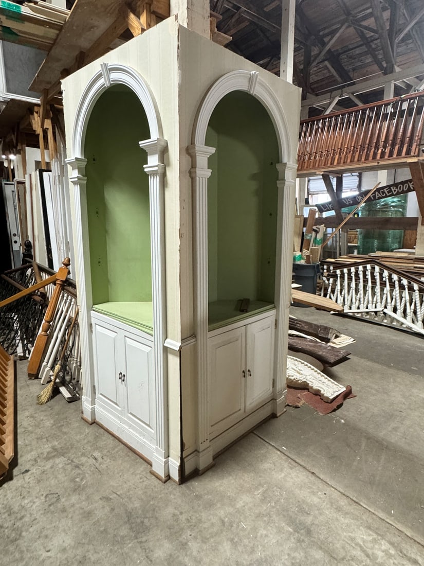 Pair of custom corner china cabinets: Reclaimed pair of custom built, corner china cabinets with arched top and keystone and fluted trim detailing. Upper open triple shelves and lower double cabinet. Measurements: 36"w x 97" t x 18" d