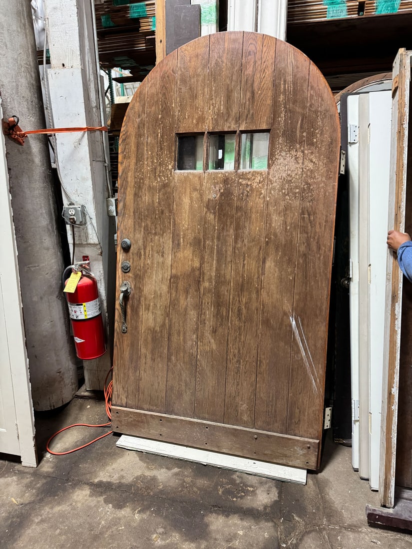 Reclaimed solid oak arched top entry door with three windows: Reclaimed solid oak arched top front door c.1920 with three-lights. No frame. Door handle hardware included: Measurements: 47 1/2" x 88" x 2 1/2"