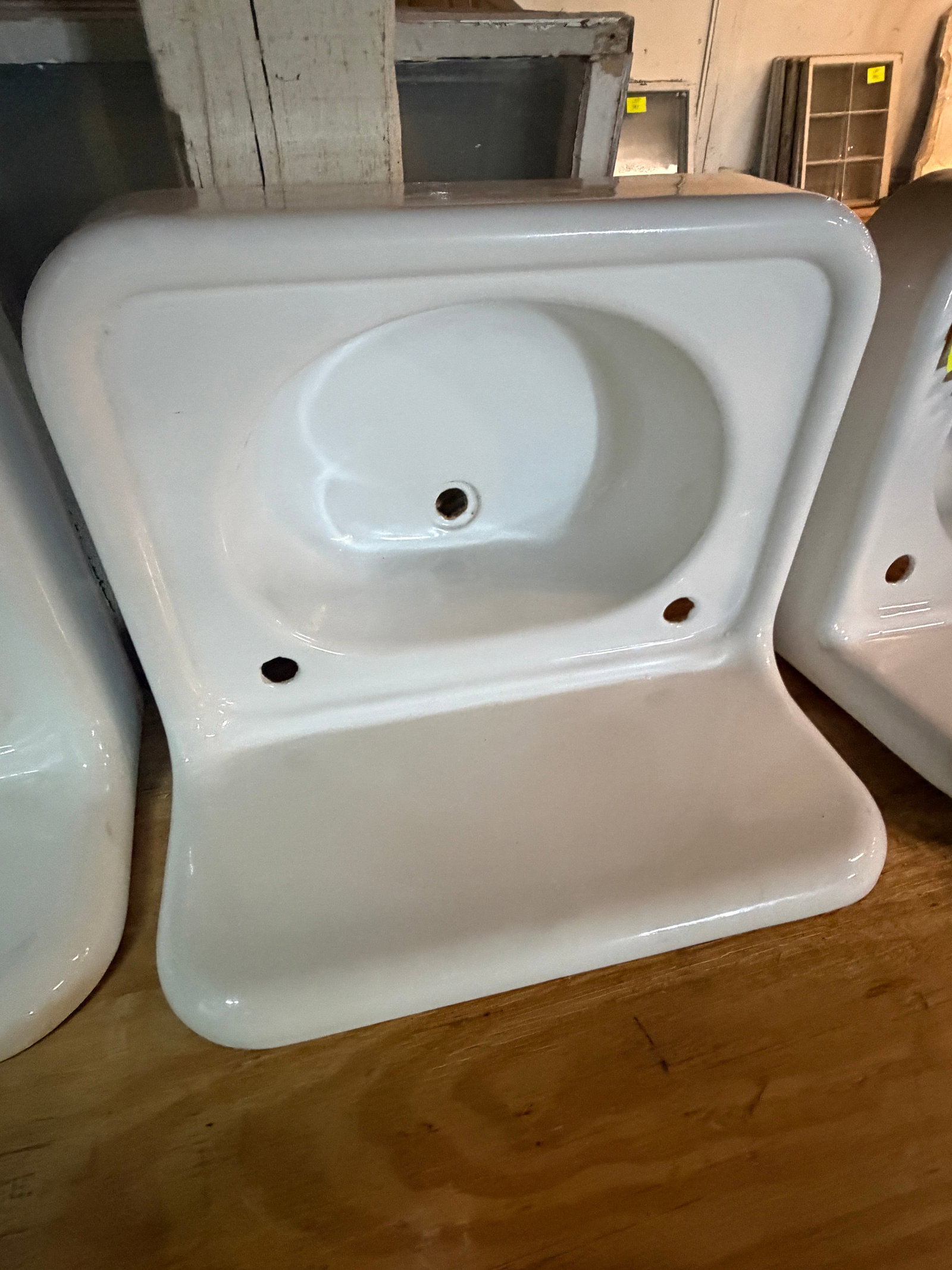 Reclaimed vintage professionally refinished high back cast iron wall mounted sink: Reclaimed, vintage, professionally refinished wall mounted high back cast iron bathroom sink.Measurement: 24" w x 18"d x 11" t
