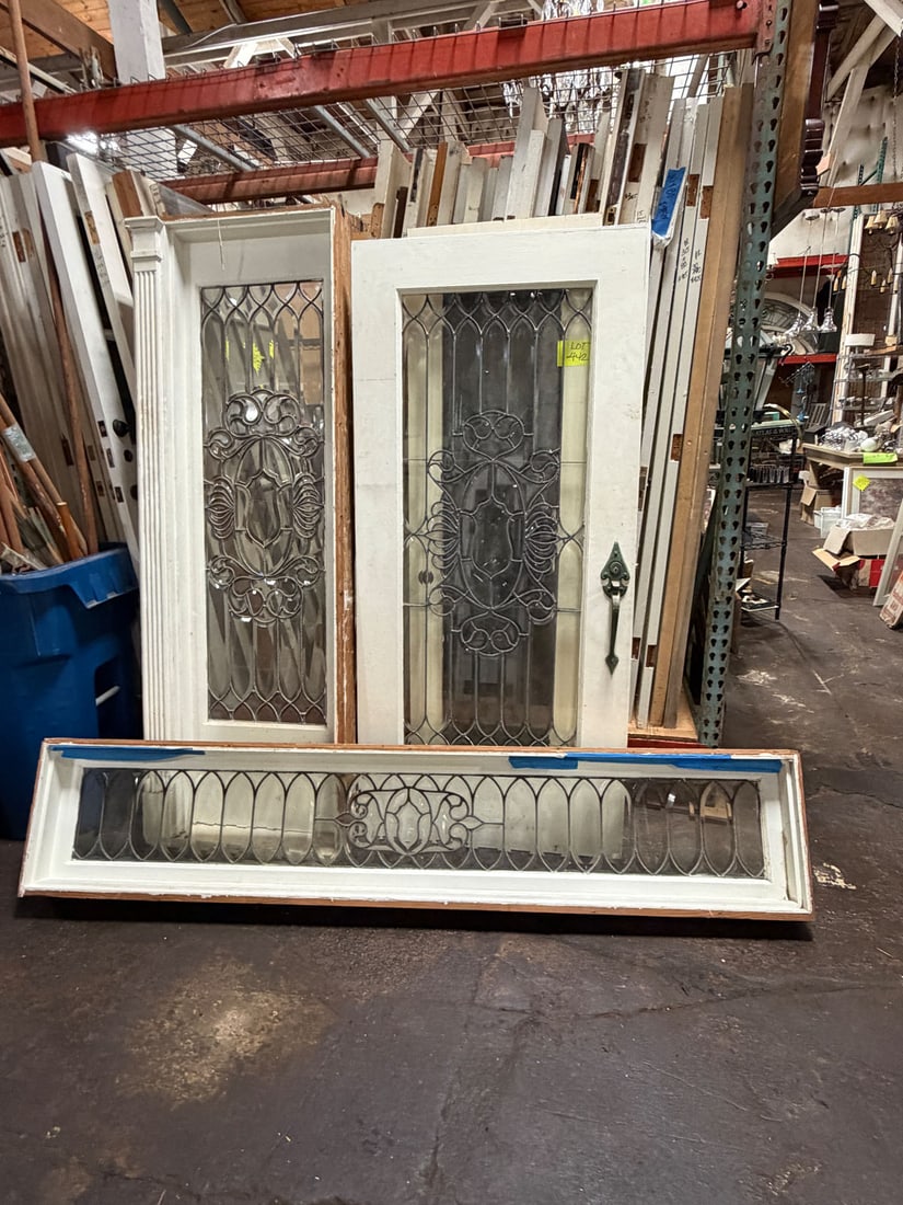 New Orleans leaded glass door with matching pair of sidelights and transom: Originally from New Orleans c. 1920's. Leaded and beveled glass entry door set with pair of matching leaded and beveled glass sidelights and transom. Measurements: Door 36" w x 78.5"tMeasurements: Sid