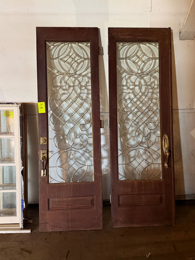 Reclaimed pair of mahogany and leaded glass entry doors: Reclaimed pair of mahogany and leaded glass entry doors from Music World Entertainment-Beyounce's fathers company located in an historic house on Hadley Street. Measurements: 30" x 94.5"