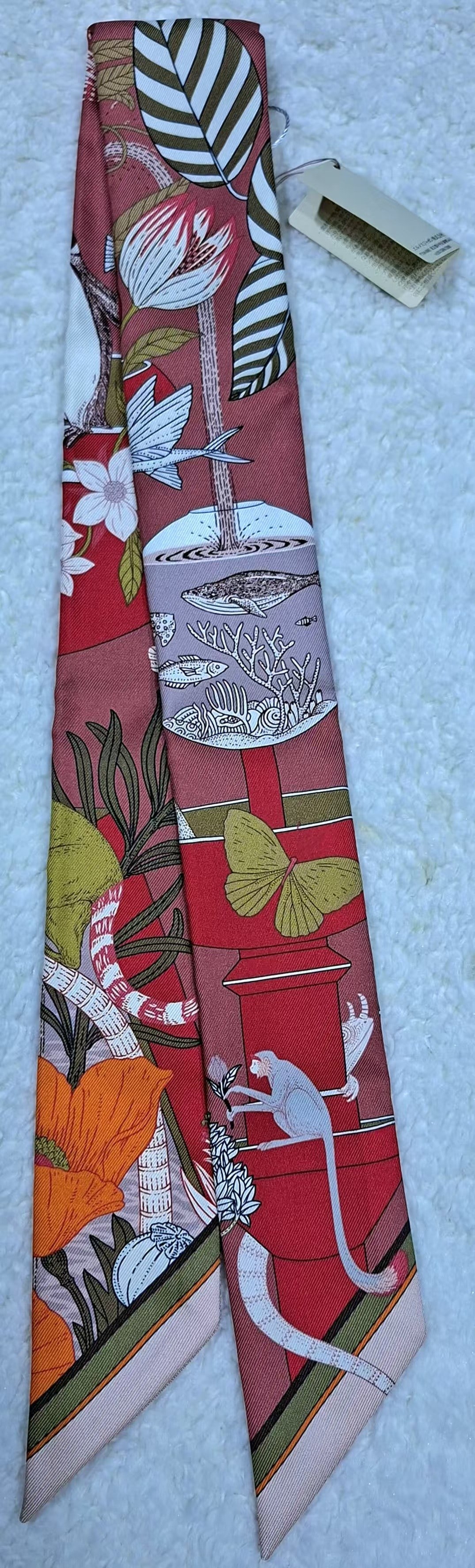 HERMES Precious Paradise Rouge Multi Silk Twilly: Item Name:Hermes Precious Paradise Rouge Multi Silk Twilly Brand:Hermes Model No.:H064094S 07 Sizs:86cm*5cm Material:Silk Accessories:N/A