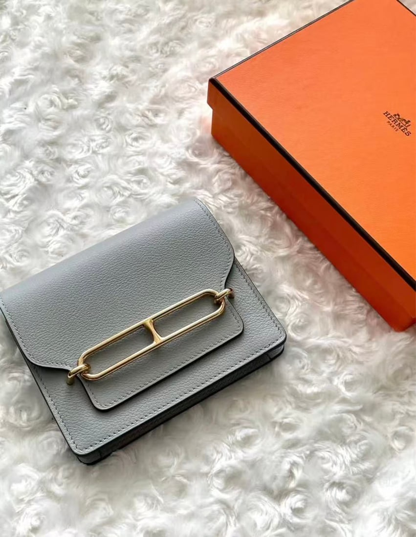 HERMES Blue Pale Roulis Slim Wallet: Item Name: Hermes Roulis Slim Blue Pale Golden Buckle Wallet Brand: HERMES Model No.: Z AM 006 UH Sizs:12.5cm*10.5cm*2cm Color:Blue Pale Material:Sheepskin Leather Accessories:Card/Dust Bag/Box