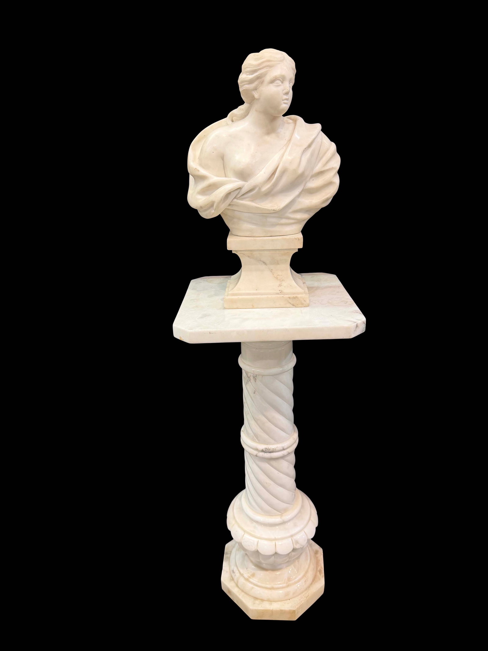 MARBLE LADY BUST STATUE SHOWING ONE BREAST ON A MARBLE PEDESTAL, HAS STAINS ON STATUE AND PEDESTAL,: MARBLE LADY BUST STATUE SHOWING ONE BREAST ON A MARBLE PEDESTAL, HAS STAINS ON STATUE AND PEDESTAL, SOME MINOR CHIPS, STATUE SIZE 17 1/2"H X 11 1/2" W , PEDESTAL SIZE32"H X 14"W